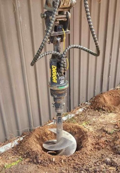 our-earthmoving-contractors-digging-a-fence-hole-for-a-new-Adelaide-business-600x663